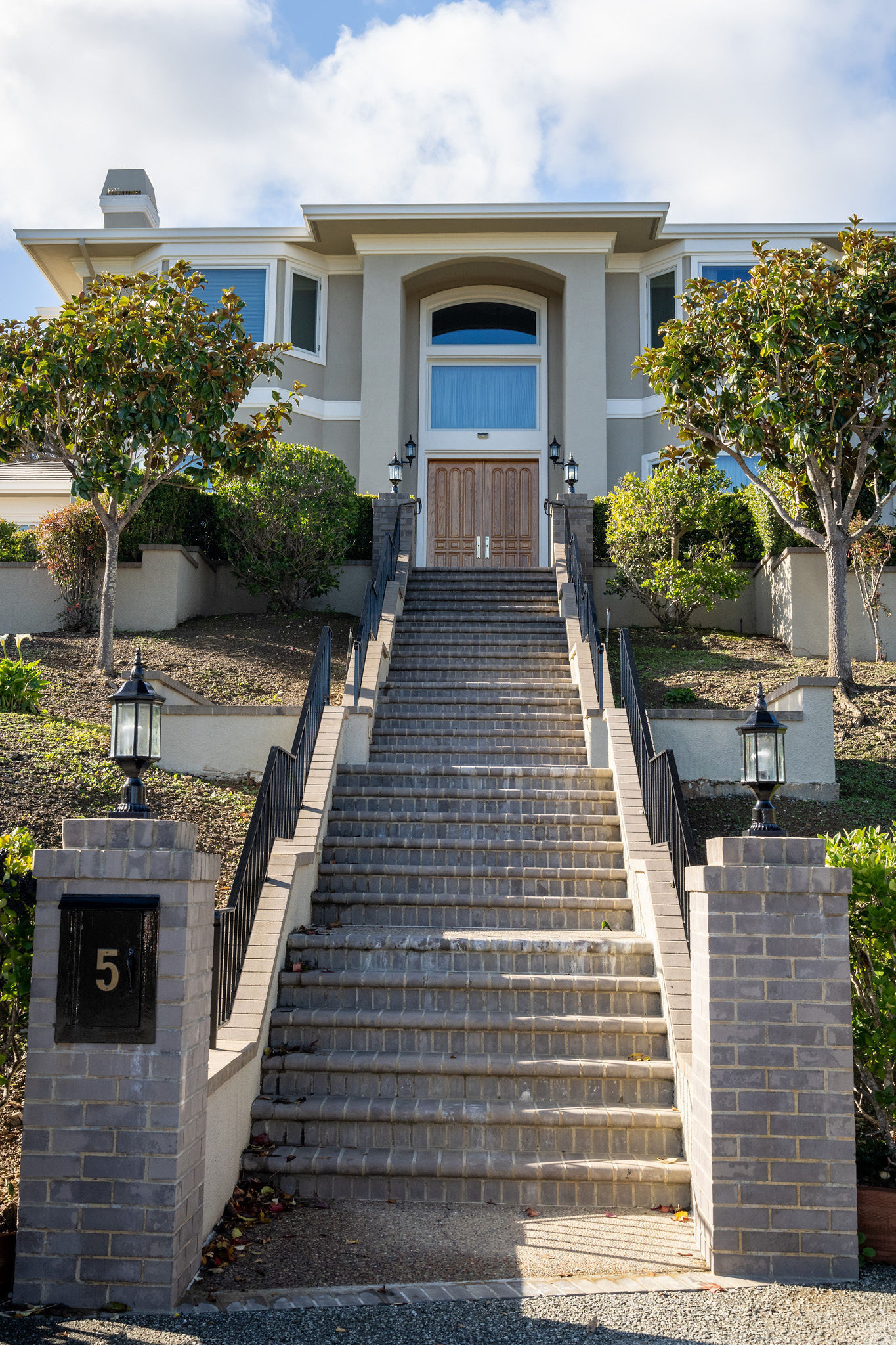 Baywood Knolls brick pillars with lamps and long steps to the front door in San Mateo.