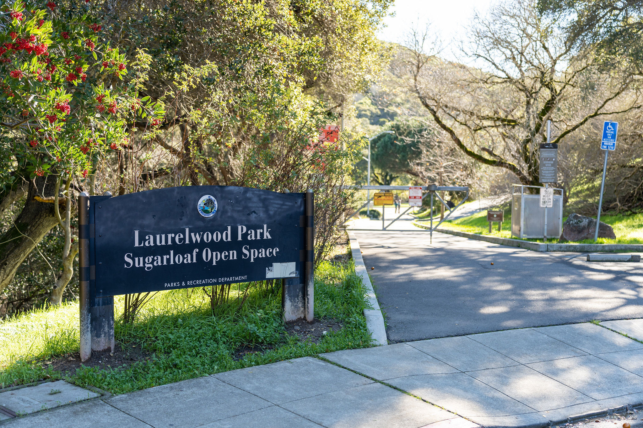 Laurelwood Park Sugarloaf Open Space signage on a black background in San Mateo.