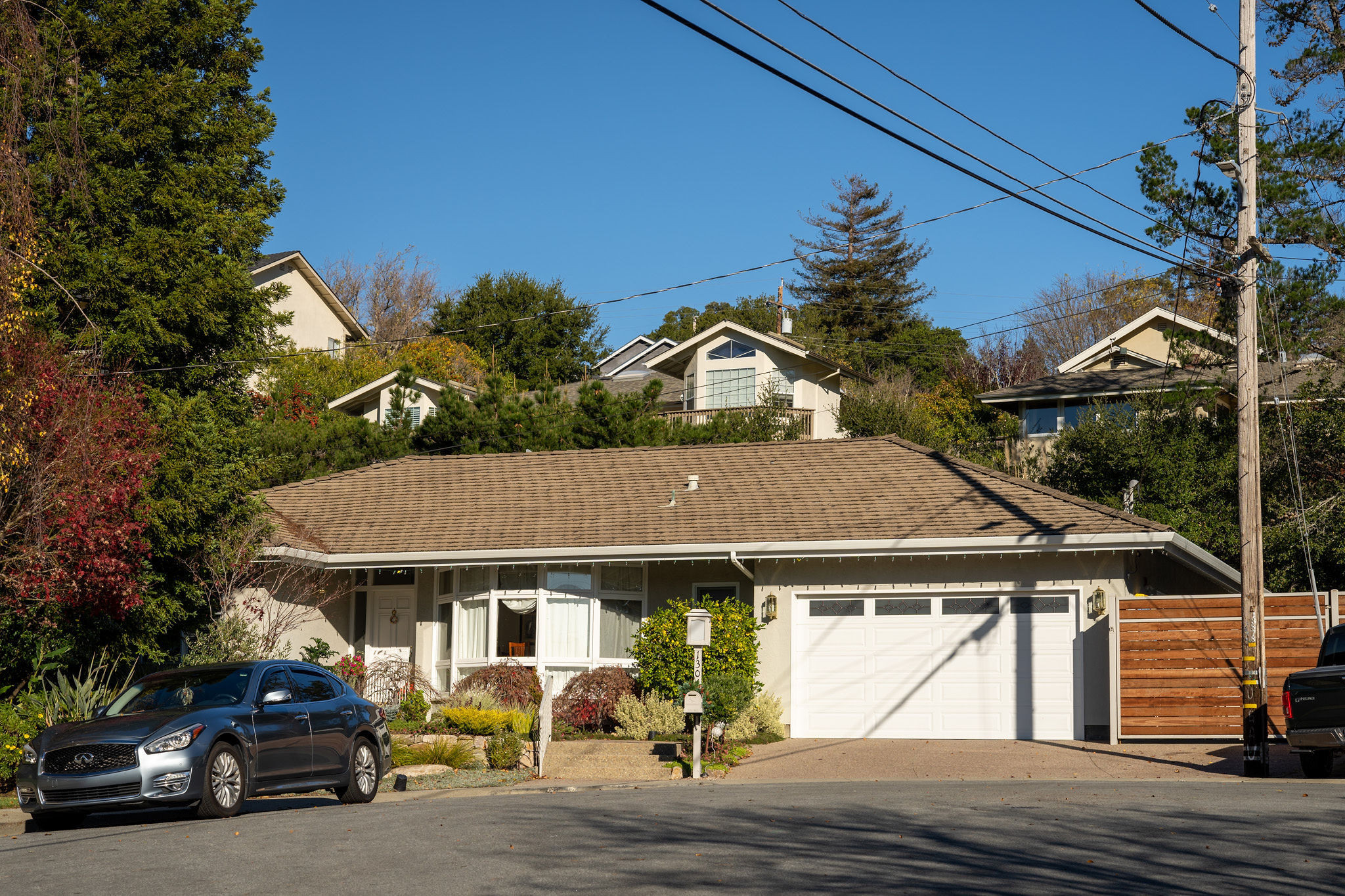 Baywood Park/Enchanted Hills Ranch style house with a white garage door in San Mateo.