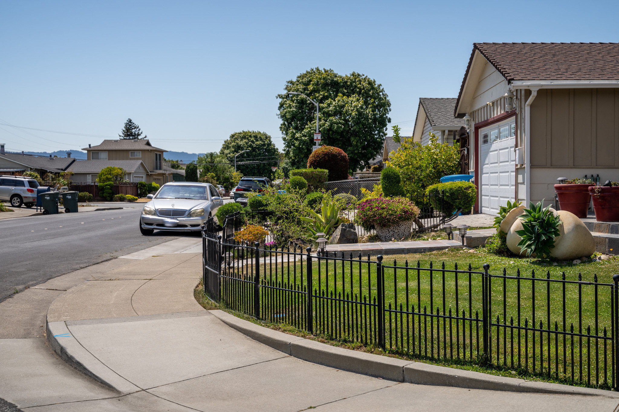 Tan craftsman home with iron fence  in the Parkside area in San Mateo