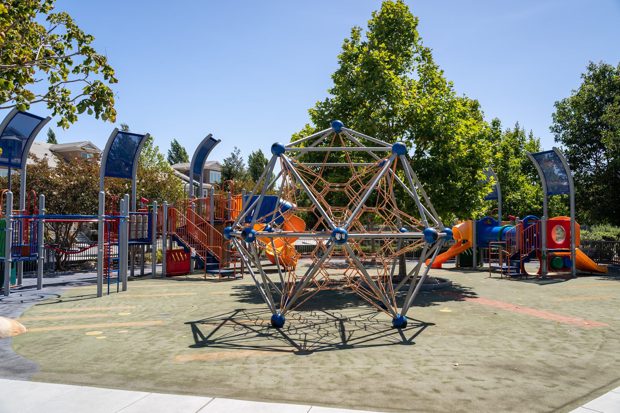 Bay Meadows/Fiesta Gardens playground with orange slides and blue monkey bars in San Mateo.
