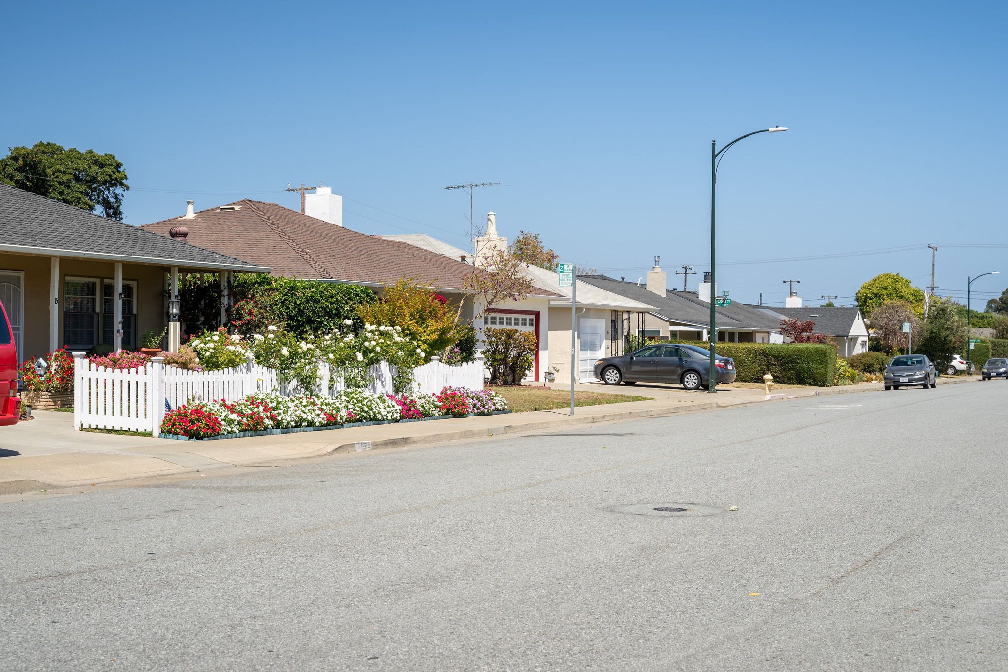 Street view with flowers bordering sidewalk in The Village area in San Mateo