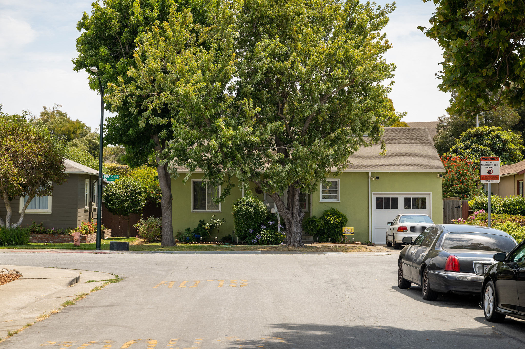 Green craftmans home with maple tree in the Shoreview area in San Mateo