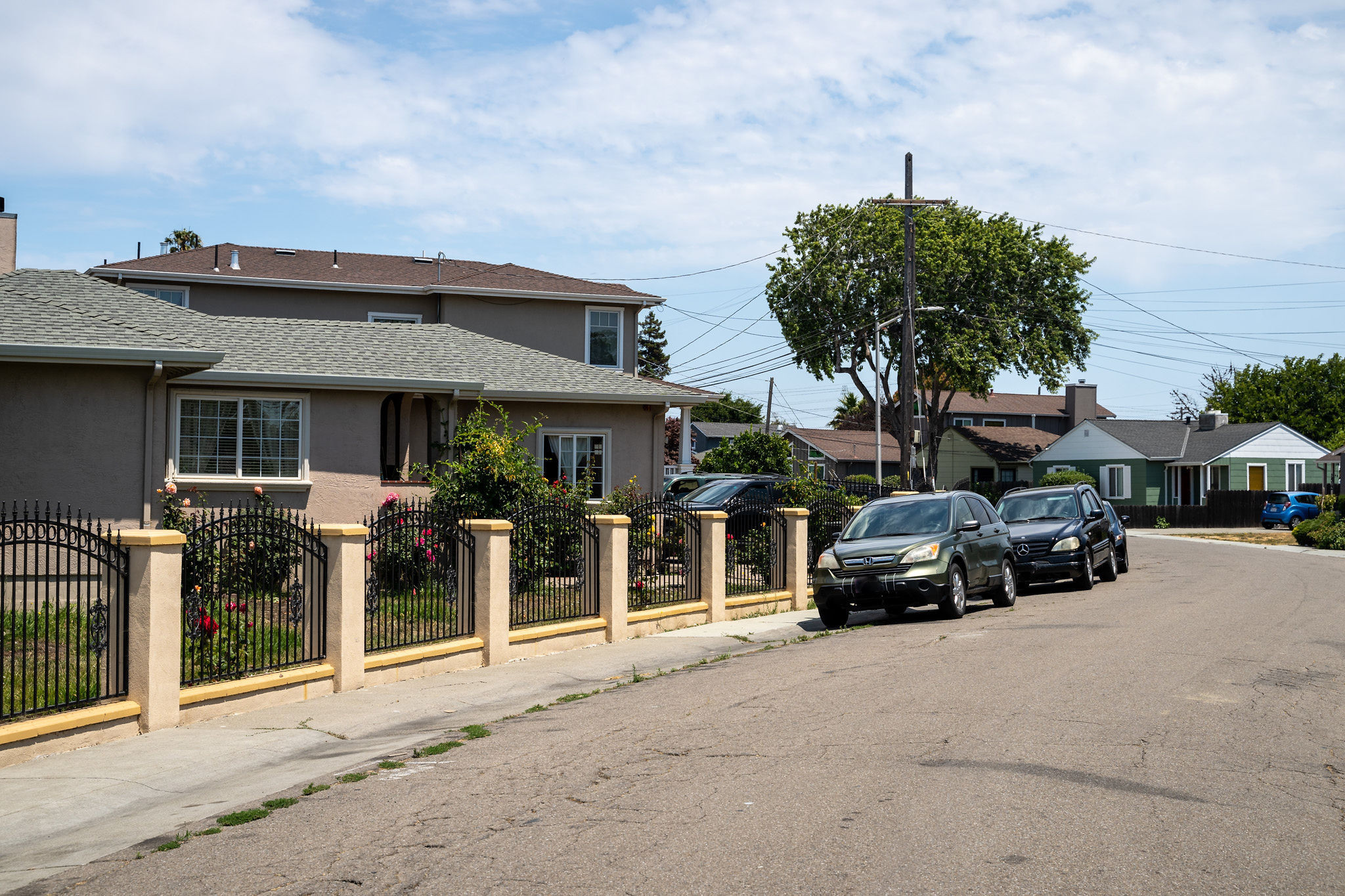 Street view with home and black cars on street in the Shoreview in San Mateo
