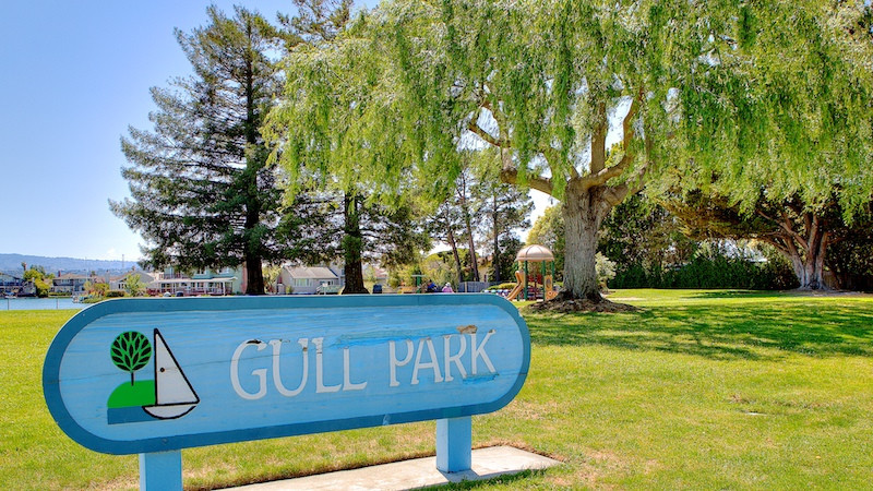 Gull Park signage on on a blue painted sign board in Foster City.
