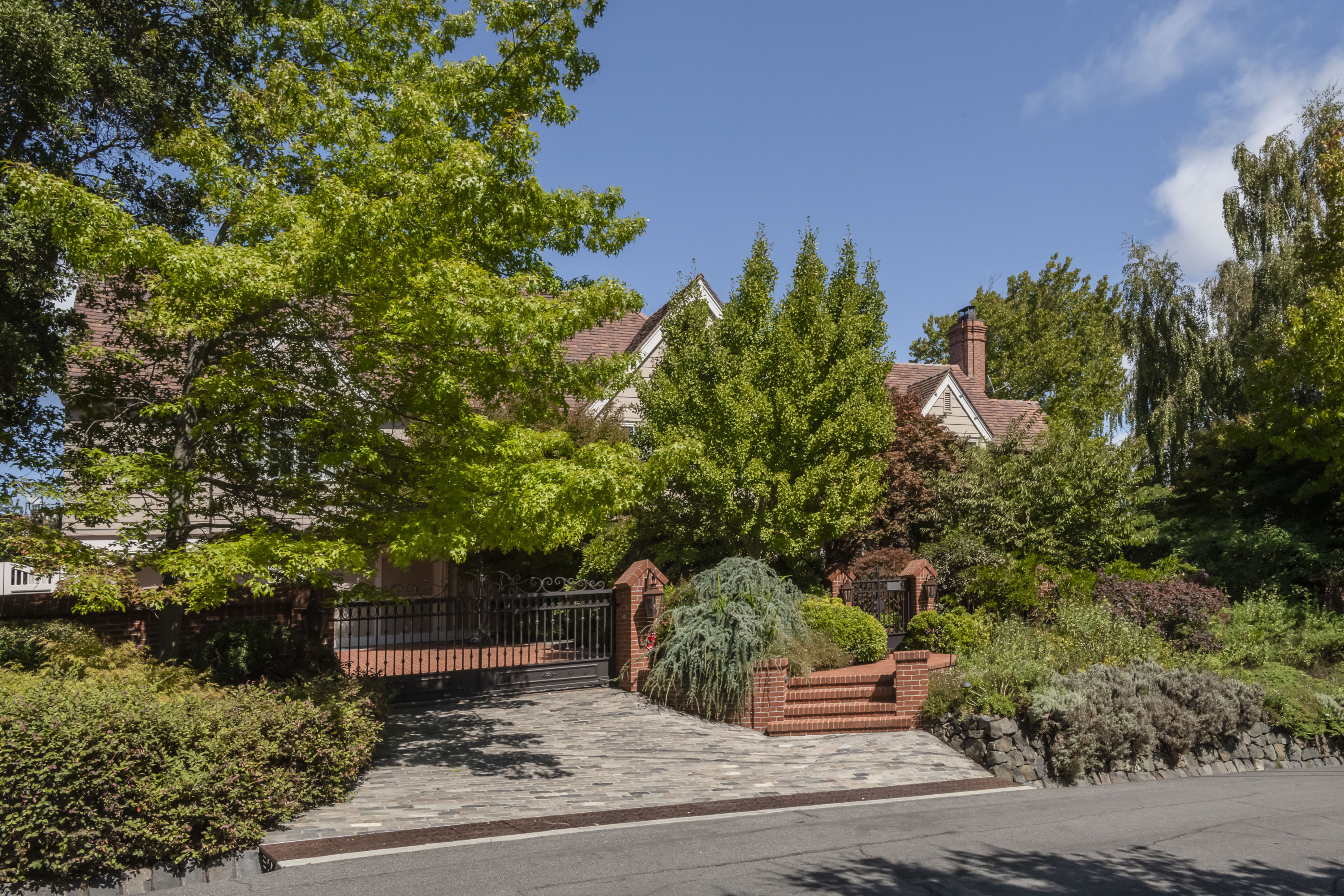 Burlingame Hills home with a steel gated driveway and brick layered steps and walkway in Burlingame.
