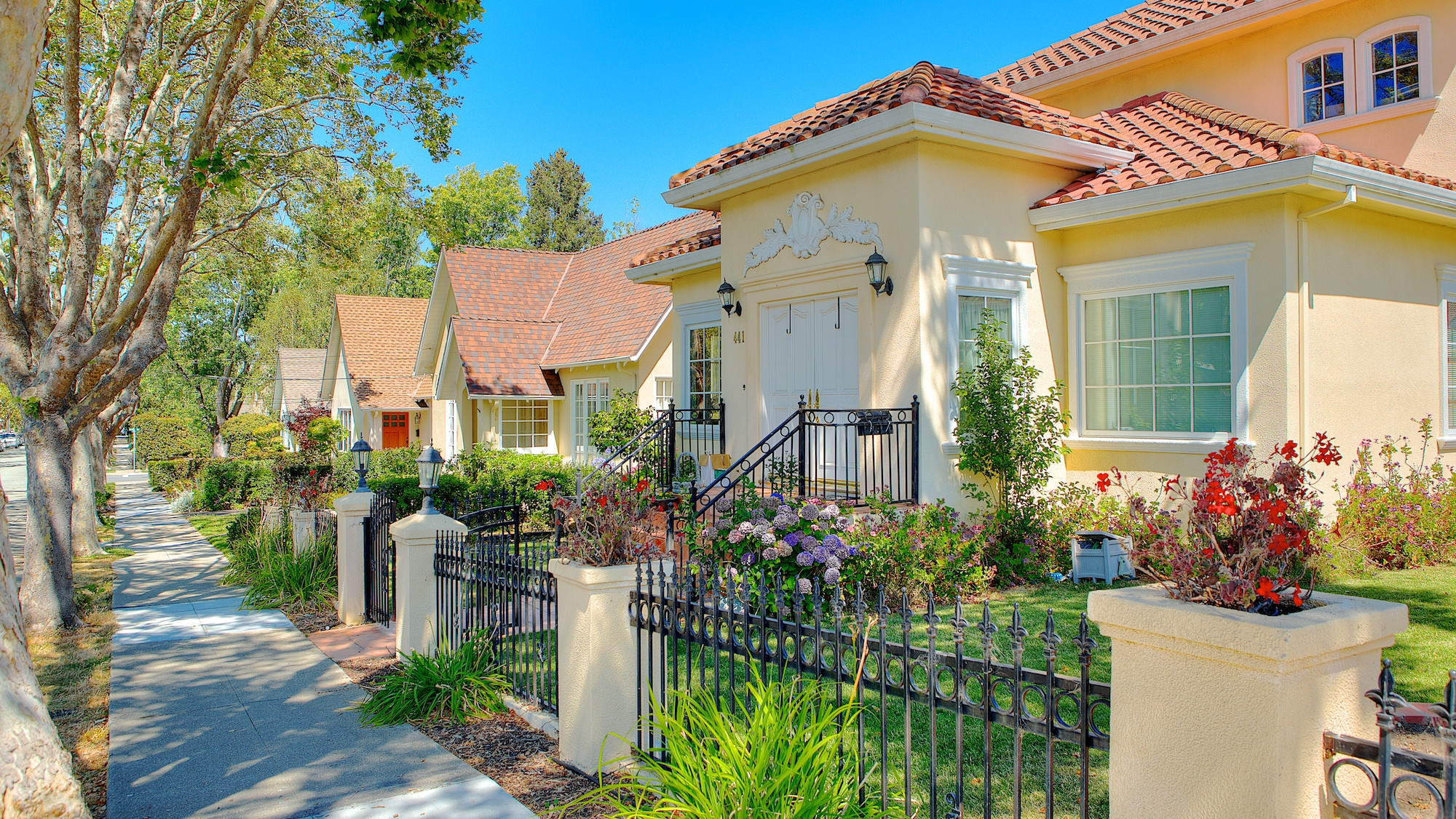 Spanish style house with iron fence and cement columns in San Mateo.